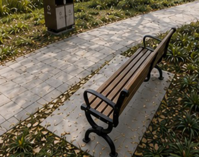 View 2 of the park, bench on the right and road on the left.